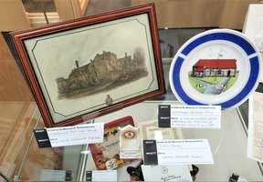 Collection of items including a picture of a house and a plate with a house on it