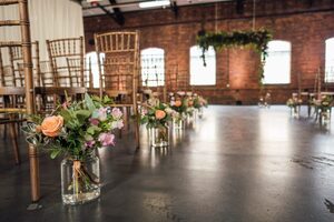 Flowers put next to chairs, as part of the stunning backdrop at The Ironworks. 