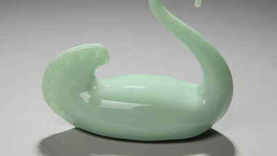 a small green glass swan