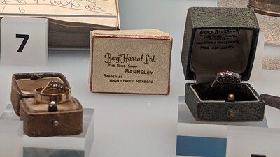 Wedding rings on display in the museum including an original Benj Harral's box