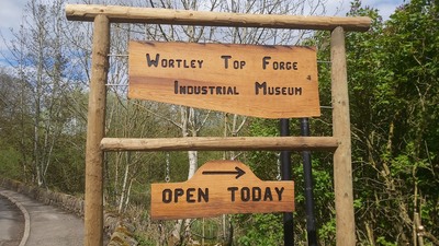 A wooden sign pointing the way to Wortley Top Forge