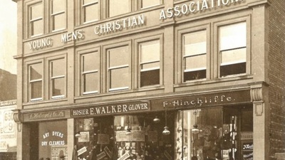 The YMCA building on Eldon Street. The ground floor has signs for E Walker Glover and F Hincliffe