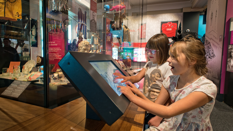 Two girls using the interactive screen display at Experience Barnsley Museum
