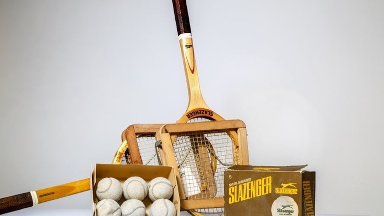 6 white tennis balls in a box, three rackets and a box with Slazenger written on it