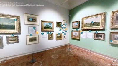 A view of the exhibition space with several paintings hung on the wall
